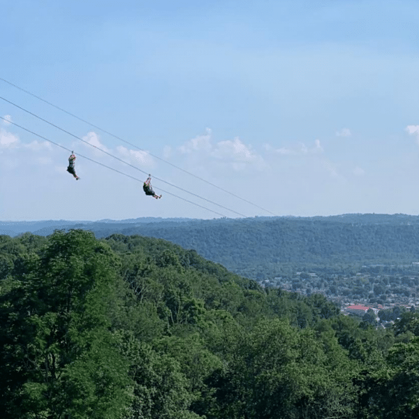 People on the ziplines overlooking the mountains at Grand Vue Adventures